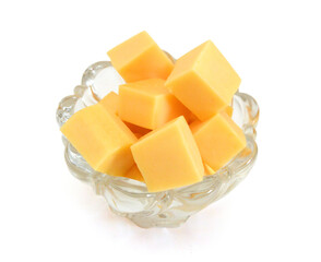 Cubes of cheddar cheese isolated on white