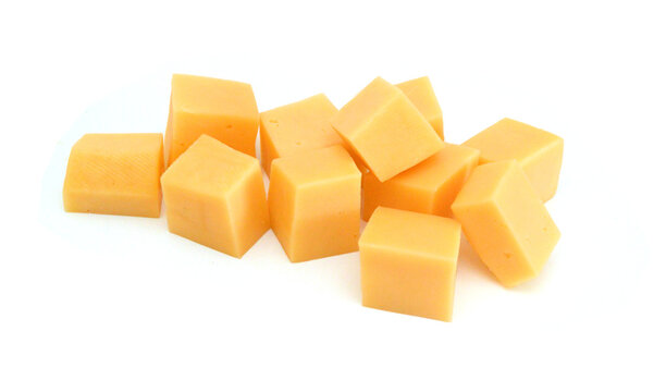Cubes of cheddar cheese isolated on white