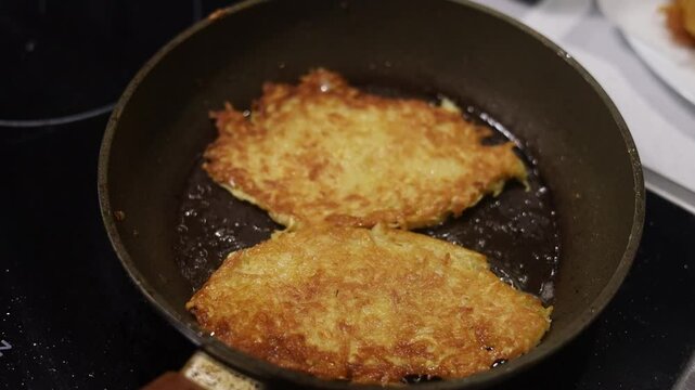 Potato food. Delicious golden draniki are cooked on a frying pan