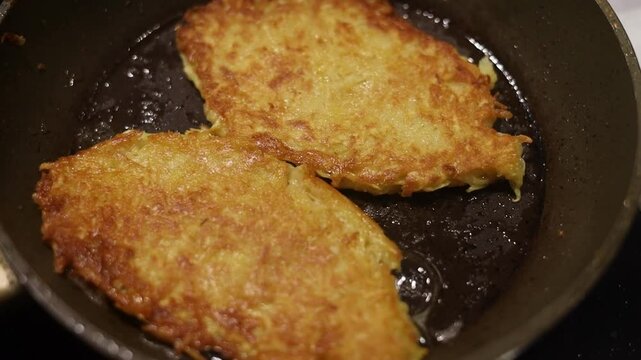 Potato food. Delicious golden draniki are cooked on a frying pan