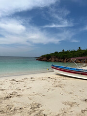 Peaceful Beach with Clear Waters and a Docked Boat