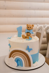 Adorable First Birthday Cake Featuring a Teddy Bear and Rainbow Design