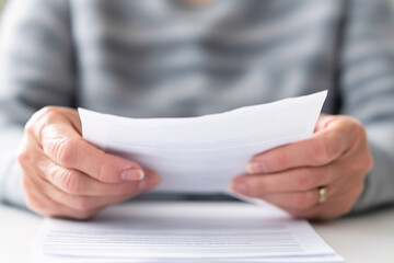 Obraz premium Closeup of Hands Holding Paper Documents Review Analysis Business Finance Office Contract Legal