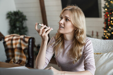 Voice application. Caucasian woman hold mobile phone talk using digital voice recorder dictate...