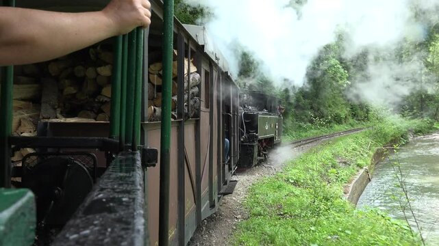 Viseu de Sus, Romania - June 05, 2017: Steam train passing through the wild landscape of Maramures mountains
