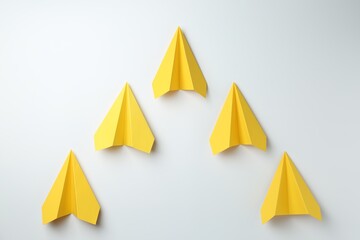 Handmade yellow paper planes on white background, top view