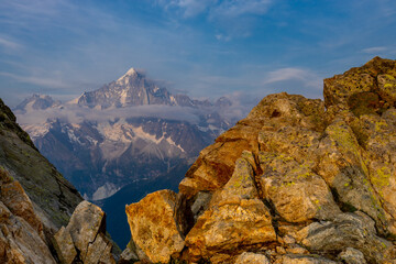 The Petit Dru mountain summit displays rugged peaks and rocky formations against clear sky. Rocky...