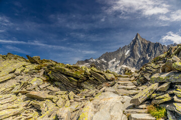 The Petit Dru mountain summit displays rugged peaks and rocky formations against clear sky. Rocky...