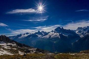 The Petit Dru mountain summit displays rugged peaks and rocky formations against clear sky. Rocky...