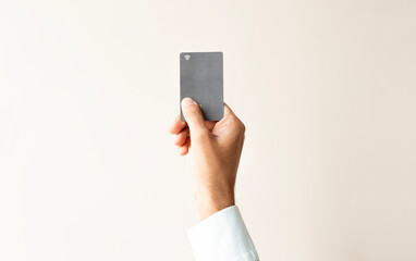 Hand showing credit card, or card, or business card or voucher, isolated on white background.