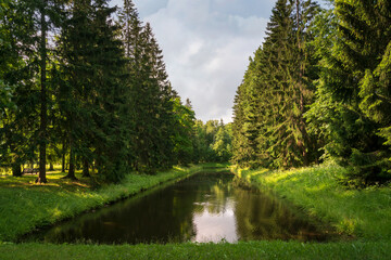 View of the U-shaped pond in the Oranienbaum Palace and Park Ensemble on a sunny summer day,...