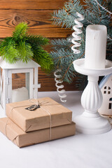 Christmas tree branches in a vase. Candlesticks with a candle New Year's toys, gifts under the tree