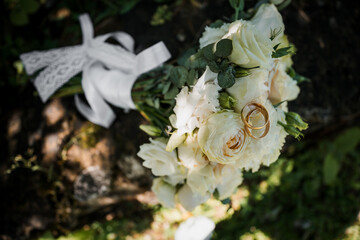 Elegant Bridal Bouquet with Wedding Rings in Natural Surroundings