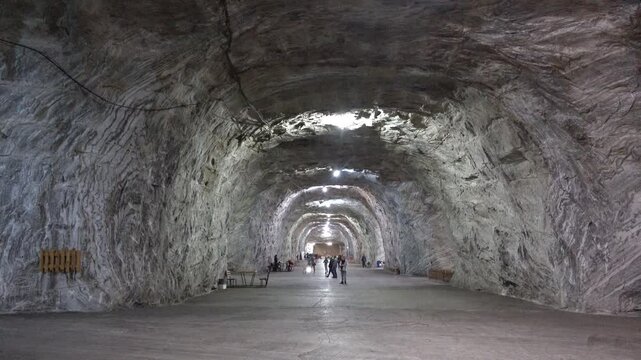 Tourists in the underground salt mine benefit of healthy saline air, Targu Ocna, Romania