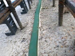 Close-up of hydrophilic waterstop and reinforced rebar structure in concrete foundation....