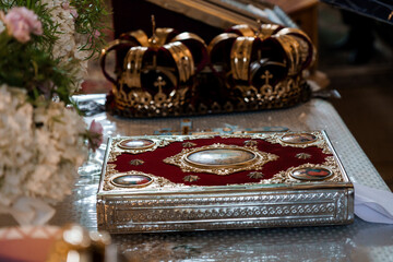Ornate Royal Crown Jewels and Decorative Book on a Table