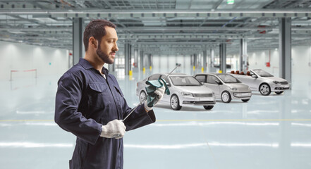 Auto mechanic cleaning a dipstick for oil check