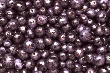Wet acai berries as background, top view