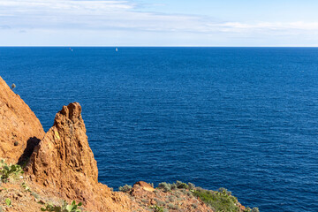 View of the Azure Mediterranean Sea with the foreground of the red rocks