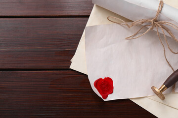 Old letters, wax stamps and envelopes on wooden table, top view. Space for text