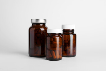 Medical bottles with pills on white background