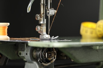 Professional sewing machine on blurred background, macro view