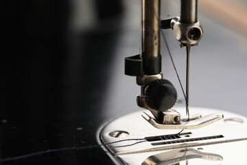 Professional sewing machine on blurred background, macro view