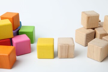 Many wooden colorful cubes on white background