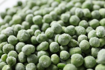 Frozen green peas as background, closeup view