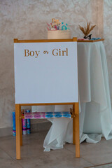 Creative Gender Reveal Setup with Chalkboard Sign and Cake