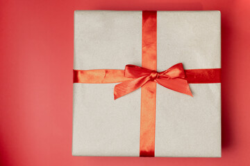 craft box with a red bow and a Christmas tree decoration