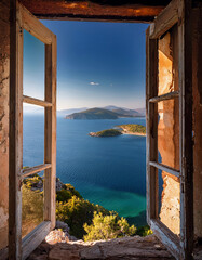 View from the window of an abandoned house overlooking the magnificent Aegean islands	
