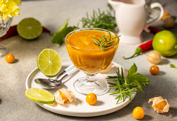 Delicious cape gooseberry sauce decorated with rosemary and lime slices