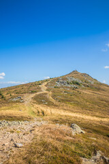 A Beautifully Serene Mountain Landscape Surrounded by a Clear and Bright Blue Sky