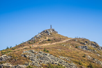 A Beautifully Serene Mountain Landscape Surrounded by a Clear and Bright Blue Sky
