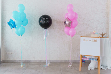 Gender Reveal Party Decorations with Colorful Balloons and a Sign