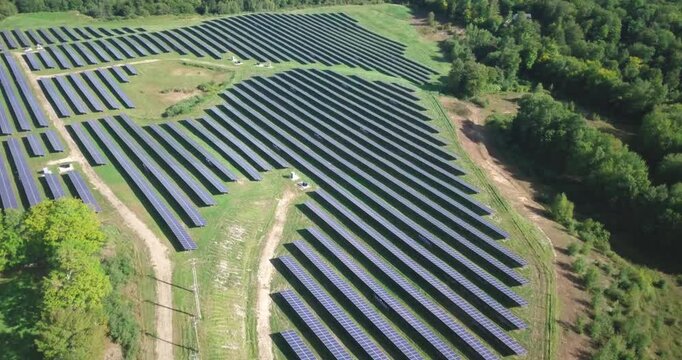 Solar panel array field from above drone shot putting power back into the energy grid on a sunshine day. Sustainable resources and renewable energy, Vermont, USA