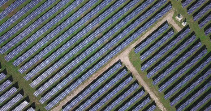 Solar panel array field from above drone shot putting power back into the energy grid on a sunshine day. Sustainable resources and renewable energy, Vermont, USA