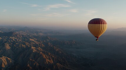 Obraz premium The vibrant hot air balloon ascends into the blue sky above the expansive desert terrain of Wadi Rum, showcasing rugged mountains and sandy vistas