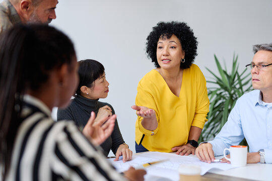 business meeting businesswoman woman office presentation colleague group teamwork seminar businessperson man businessman black asian white african american discussion team