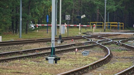 Railroad Track Junction and Road Crossing with Signal Semaphore with Blue Light Designating Railway...