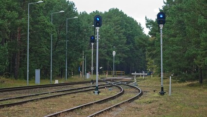Railroad Track Junction and Road Crossing with Signal Semaphore with Blue Light Designating Railway...