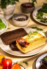 Healthy and tasty breakfast with baked cheese, rye bread and fresh vegetables