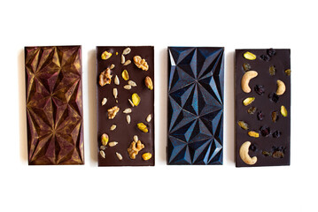 Chocolate bars in various colors with nuts, arranged horizontally on a white background. Decoration for Valentine's Day and Christmas.