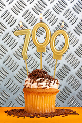 Birthday candle number 700 - Industrial metallic background.