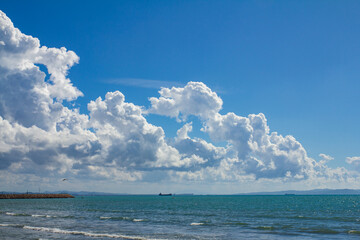 big white clouds in the deep blue sky over the sea landscape