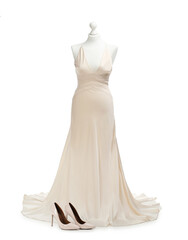 Fototapeta premium Mannequin with beautiful wedding dress and shoes isolated on white