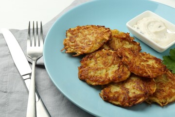 Delicious potato pancakes served on table, closeup