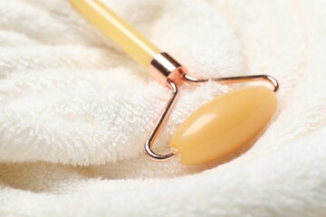 Face roller on light terry towel, closeup