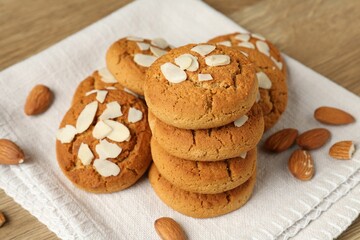 Tasty cookies with almond flakes and nuts on table, closeup